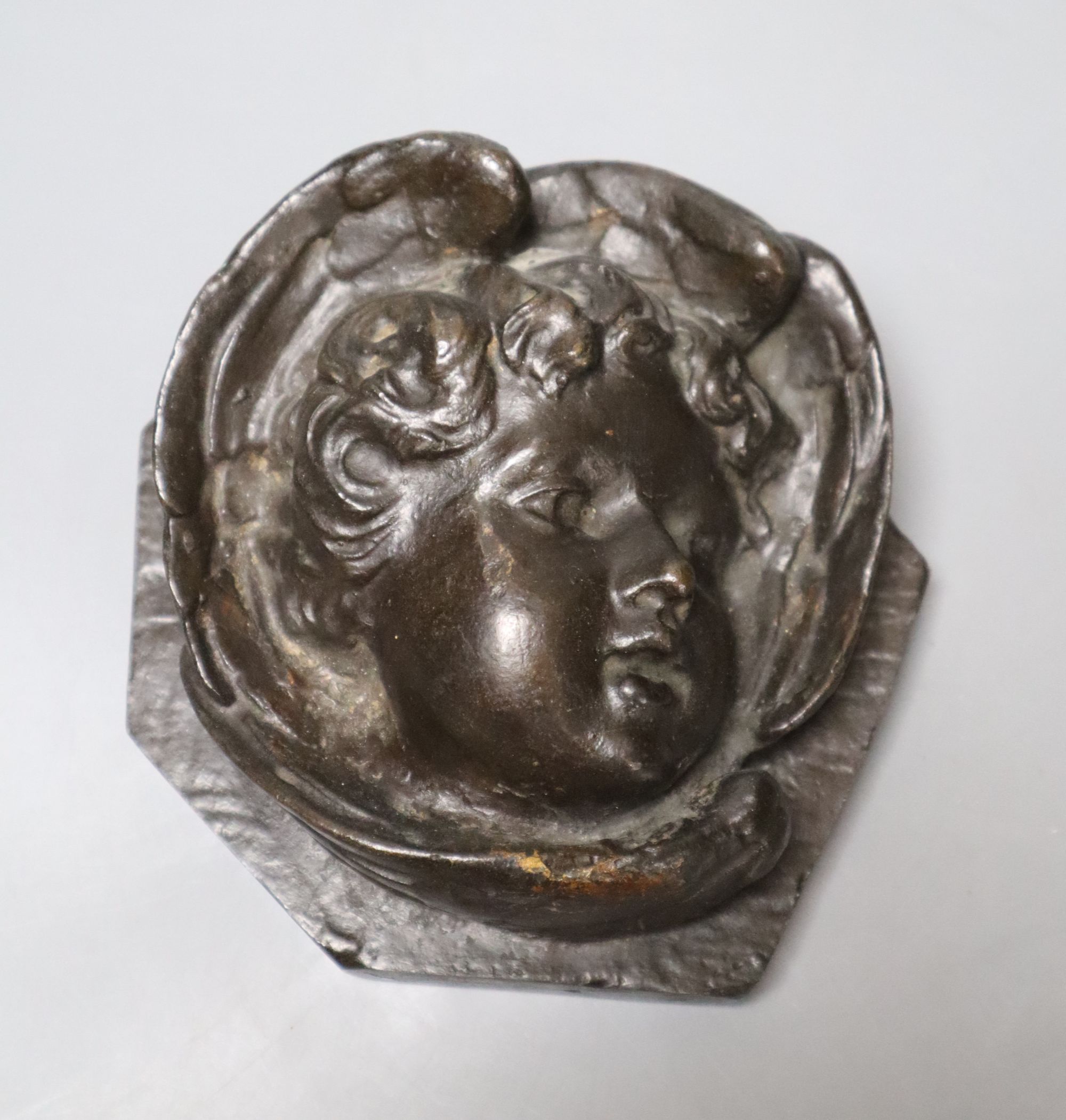 A bronze relief of a cherub, length 13cm